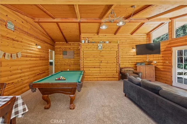 a bedroom with furniture and a flat screen tv