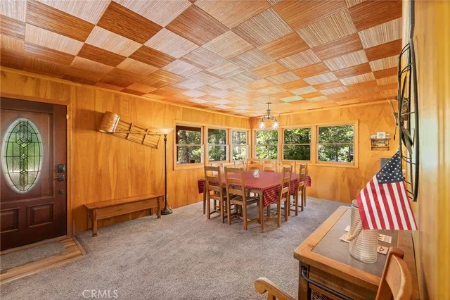 a view of staircase with a table and paintings on the wall