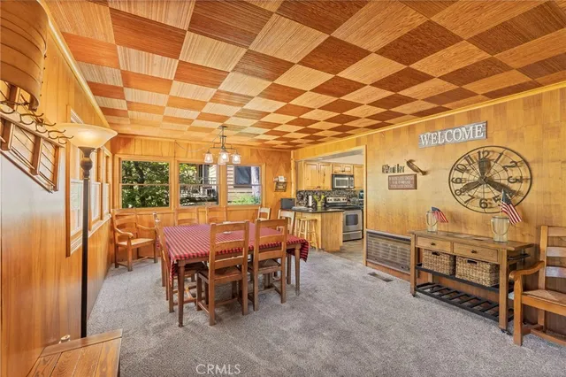 a large kitchen with kitchen island a stove a sink and a granite counter tops with garden view