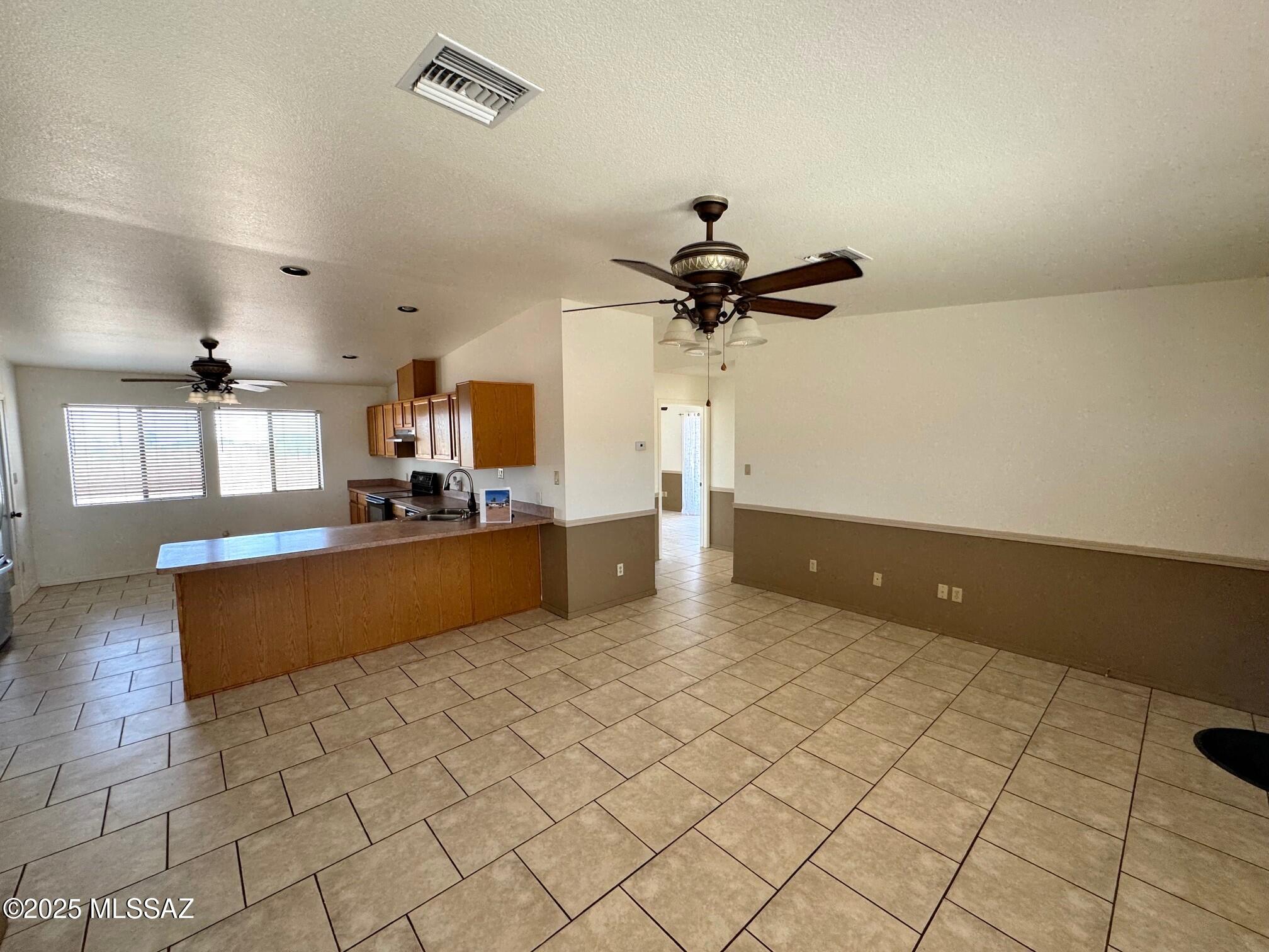 13384 South Cottonwood Road Pearce, AZ 85625 - Photo 10 of 46 a large kitchen with granite countertop a sink and a stove top oven
