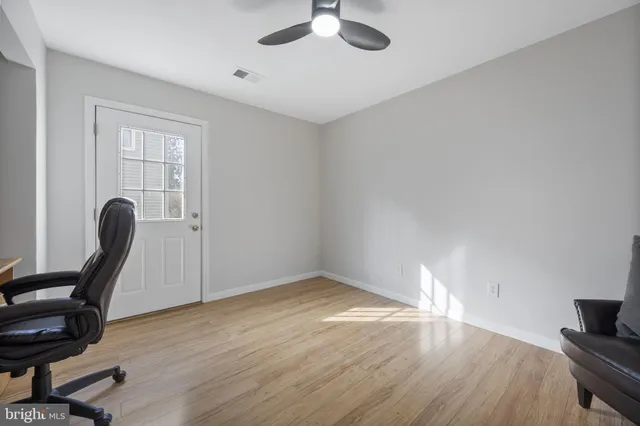 a view of workspace and wooden floor in a room