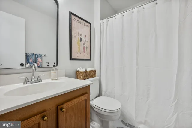 a bathroom with a shower sink and mirror