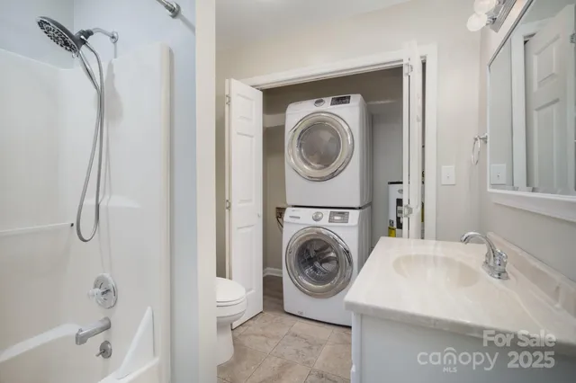 a utility room with sink dryer and washer