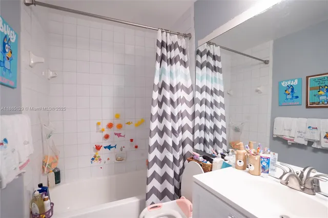 a bathroom with a sink a toilet and shower curtain