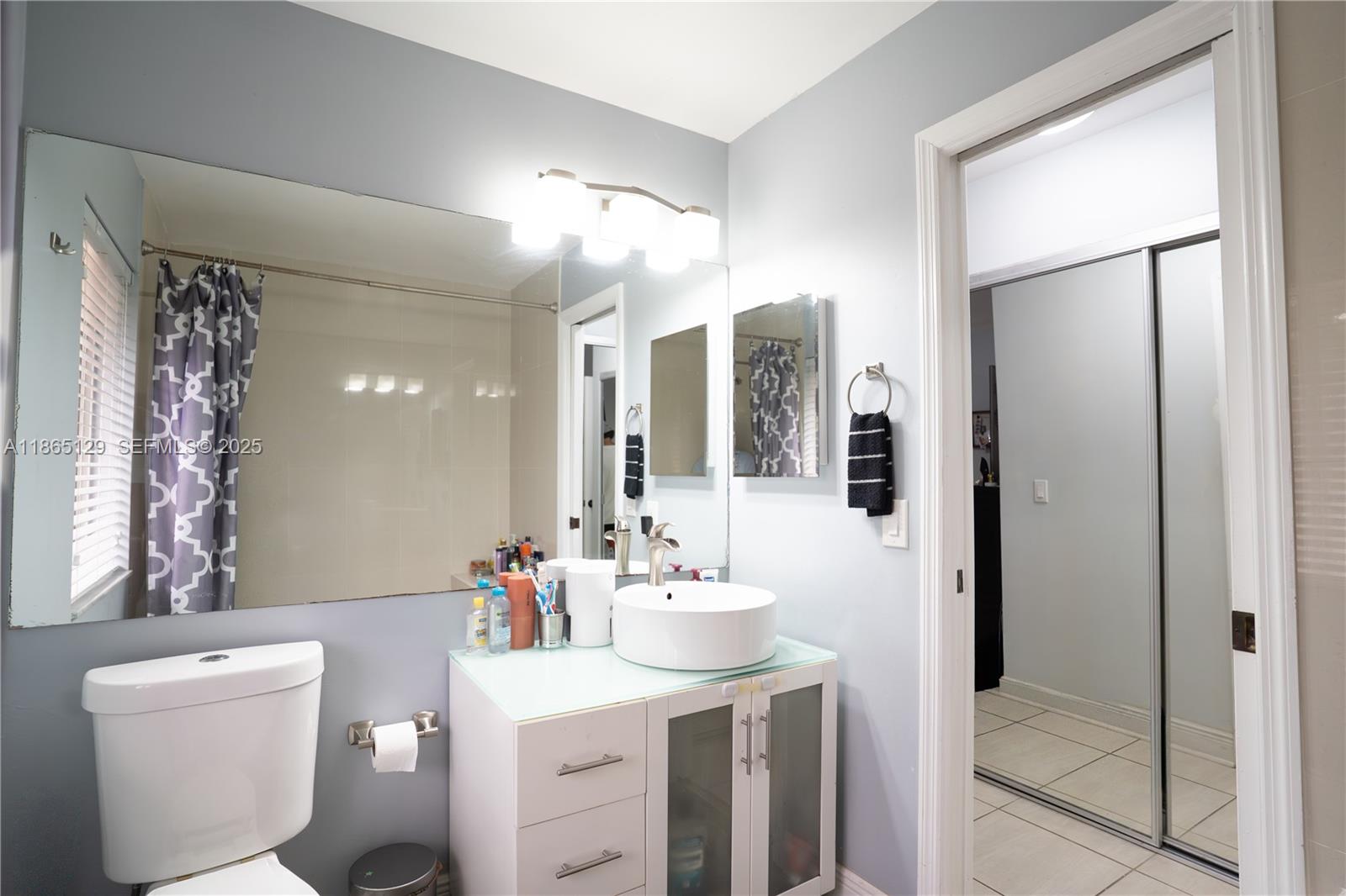 10982 Southwest 75th Terrace Miami, FL 33173 - Photo 17 of 31 a bathroom with a sink vanity mirror and toilet