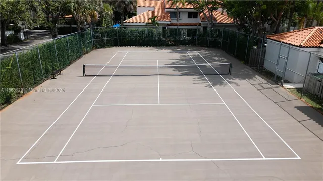 a view of a backyard with plants and brick wall