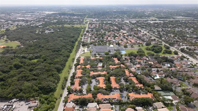 an aerial view of residential building and car parked