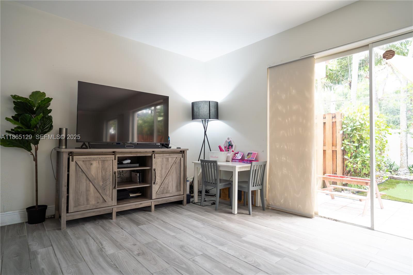 10982 Southwest 75th Terrace Miami, FL 33173 - Photo 5 of 31 a living room with furniture and a flat screen tv