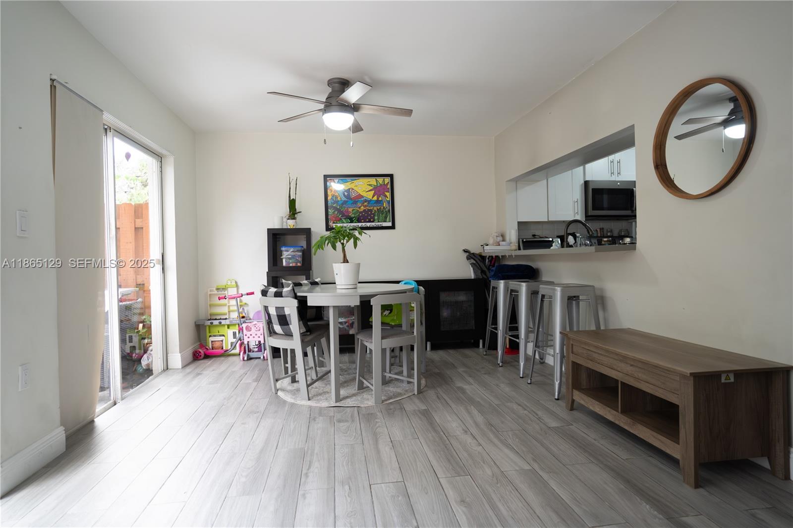 10982 Southwest 75th Terrace Miami, FL 33173 - Photo 8 of 31 a view of a dining room with furniture and wooden floor