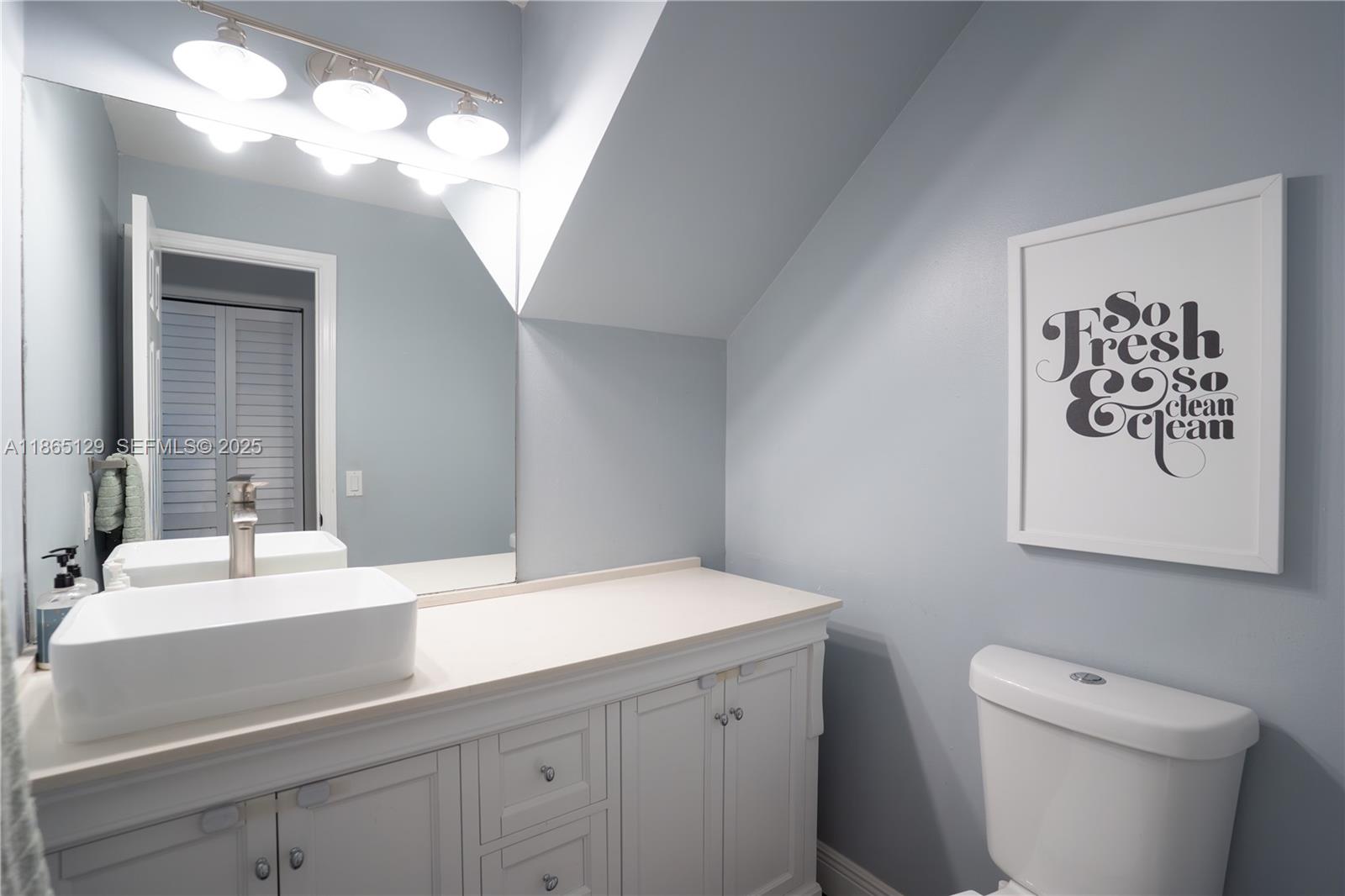 10982 Southwest 75th Terrace Miami, FL 33173 - Photo 9 of 31 a bathroom with a sink a toilet and mirror