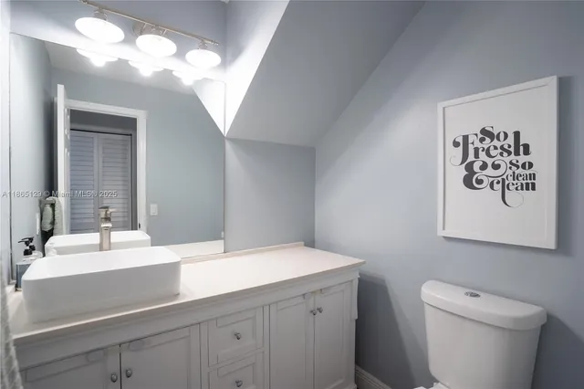 a bathroom with a sink a toilet and mirror