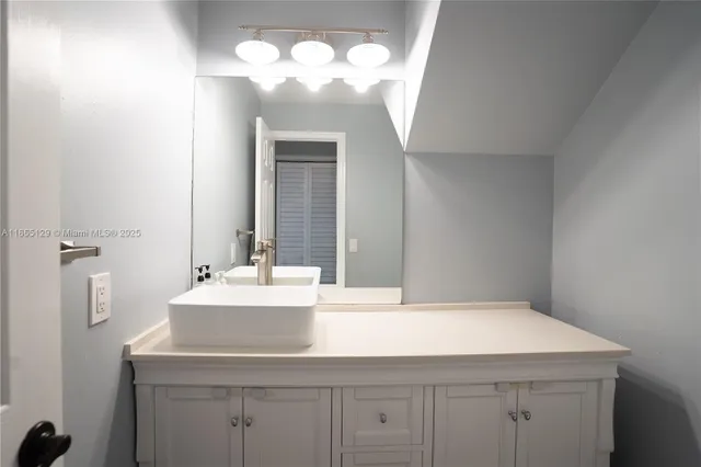 a bathroom with a sink and a mirror