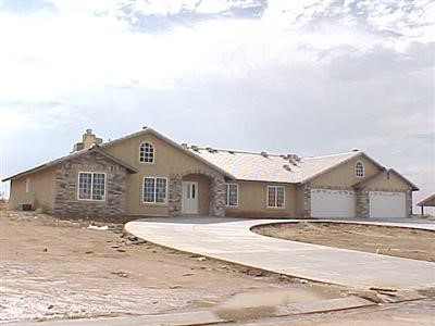 12210 Larch Road Hesperia, CA 92344 - Photo 1 of 1 a view of a white house next to a yard with large trees