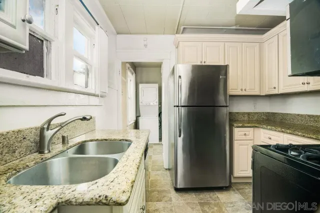 a kitchen with stainless steel appliances granite countertop a stove and a sink