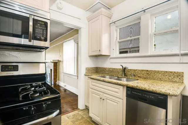 a kitchen with stainless steel appliances granite countertop a stove and a microwave