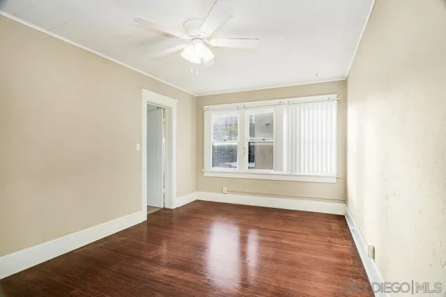 a view of a room with wooden floor