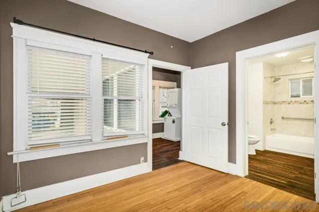 a view of an empty room and wooden floor