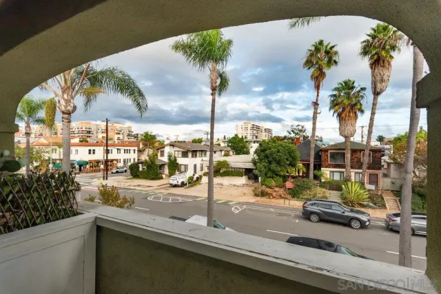 a view of an empty room with a fireplace and wooden floor