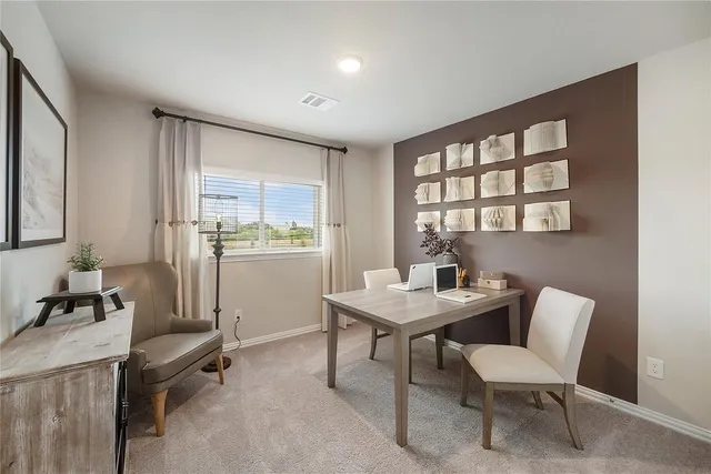 a view of a dining room with furniture and window