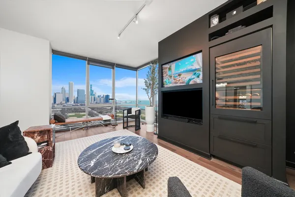 a living room with furniture a large window and a table