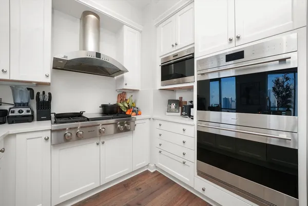 a room with white cabinets and sink