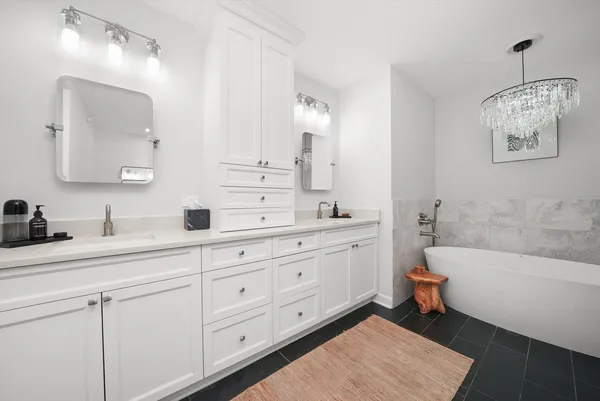 a bathroom with a tub shower and sink