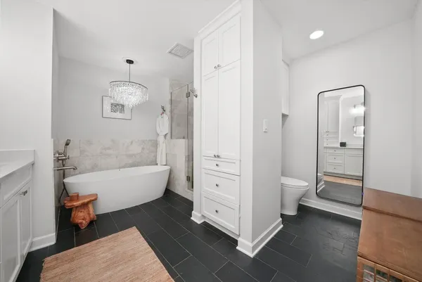 a bathroom with a white bath tub and a shower