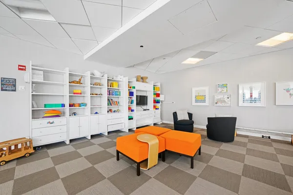 a living room with lots of furniture and a floor to ceiling window
