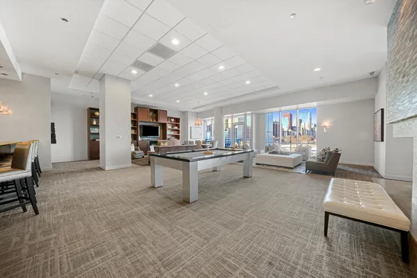 a living room with furniture a rug and a flat screen tv