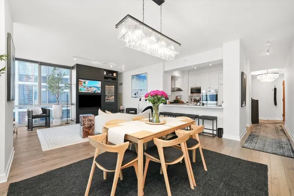 a living room with furniture and a view of kitchen