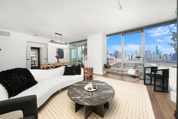 a living room with furniture a rug and a flat screen tv