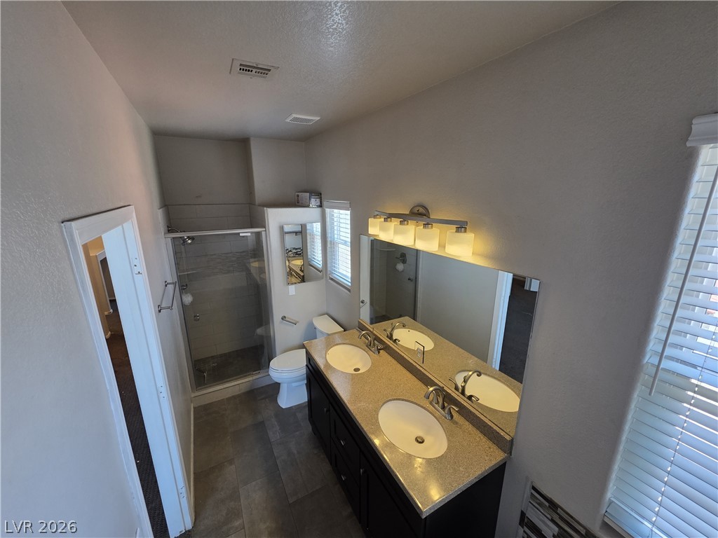 2275 Ramsgate Drive Henderson, NV 89074 - Photo 63 of 84 Granite counters and a dual vanity elevate this functional bathroom.