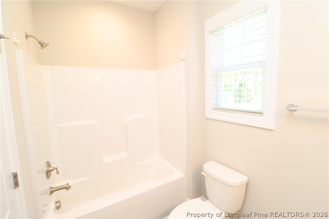 8424 Rhodes Road Apex, NC 27539 - Photo 28 of 31 a white toilet sitting next to a bathroom sink
