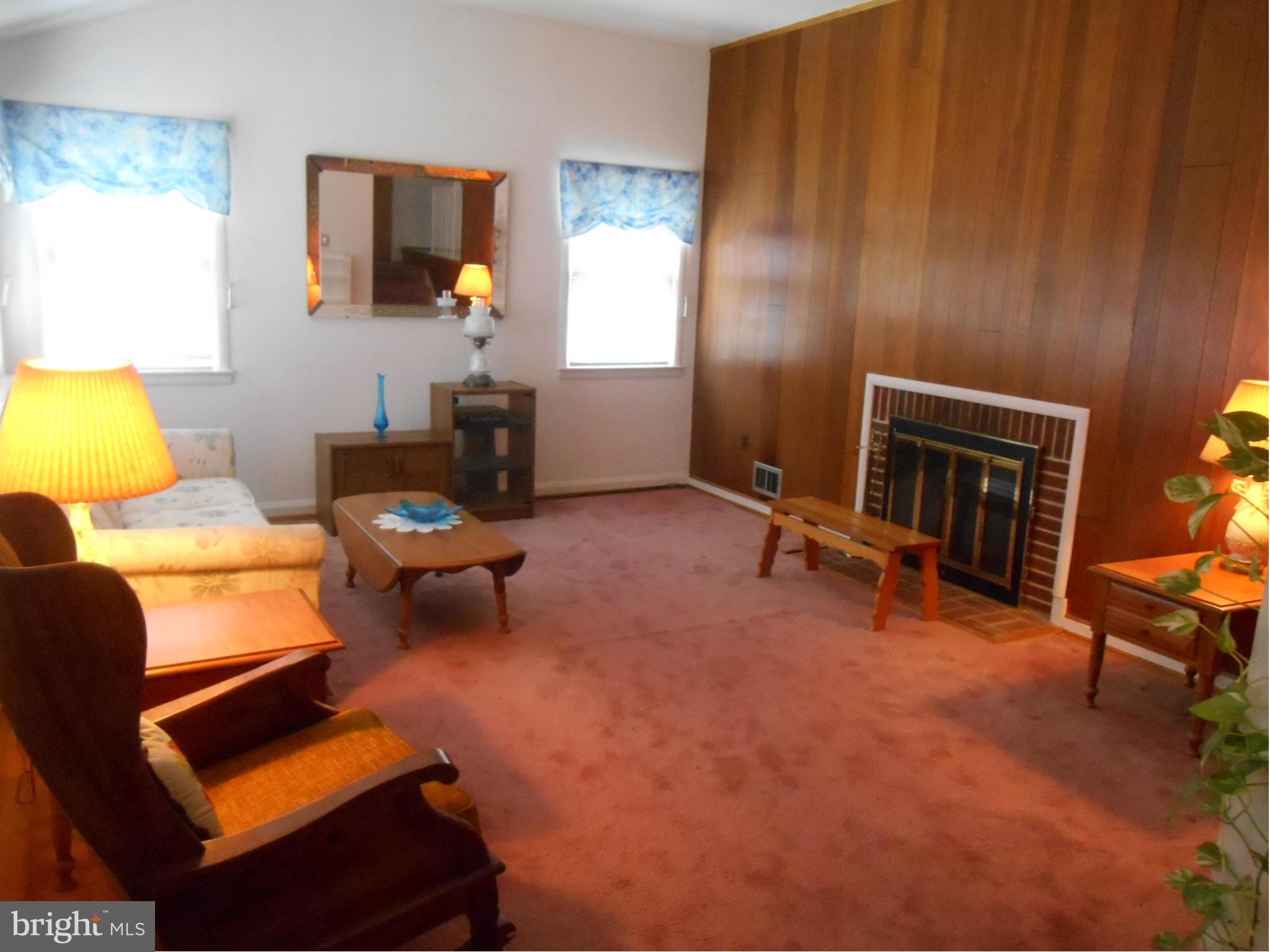 1414 Shefford Road Baltimore, MD 21239 - Photo 2 of 12 a living room with furniture gym equipment and a fireplace