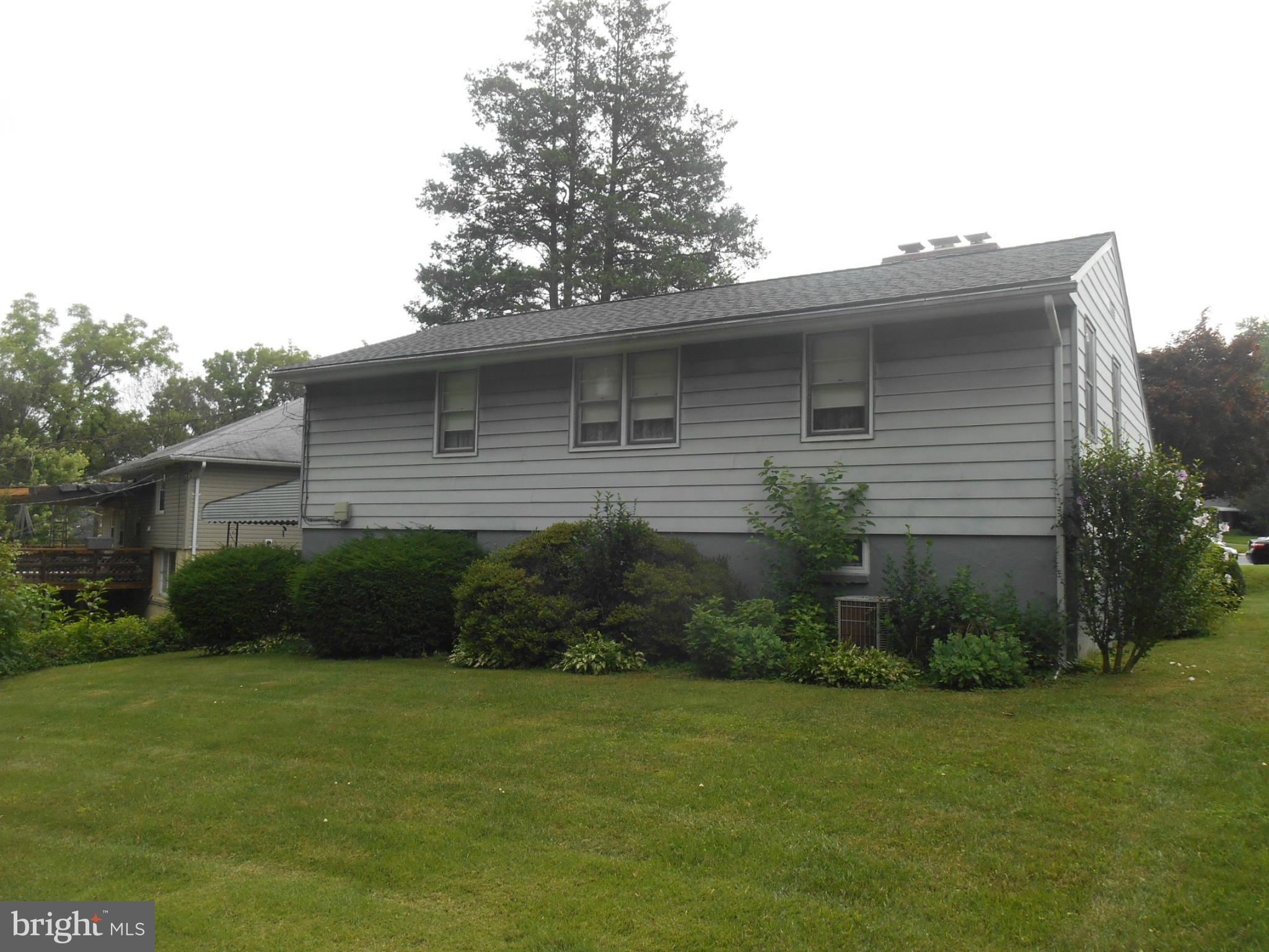 1414 Shefford Road Baltimore, MD 21239 - Photo 11 of 12 a front view of a house with a garden