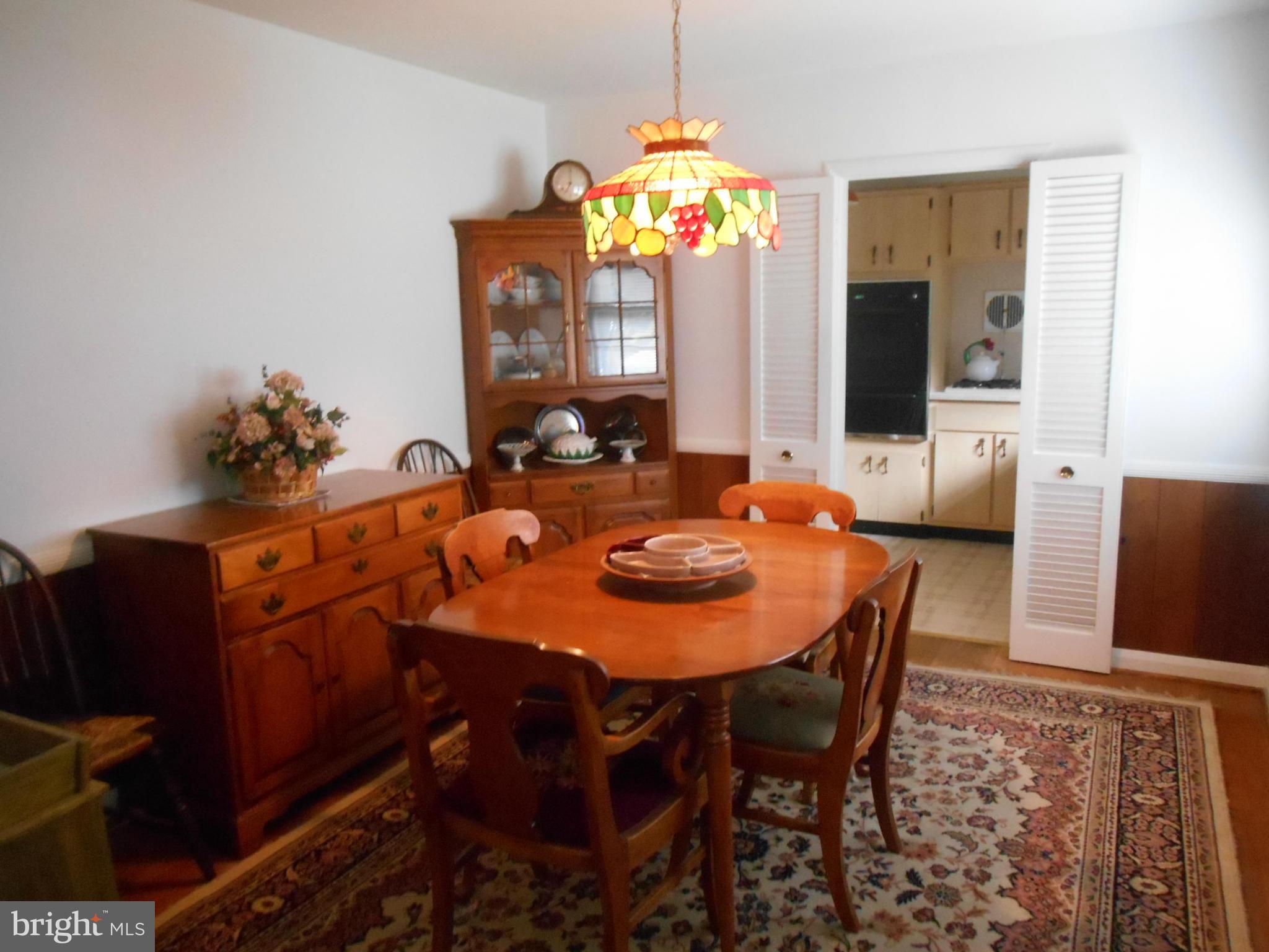 1414 Shefford Road Baltimore, MD 21239 - Photo 3 of 12 a view of a dining room with furniture and chandelier