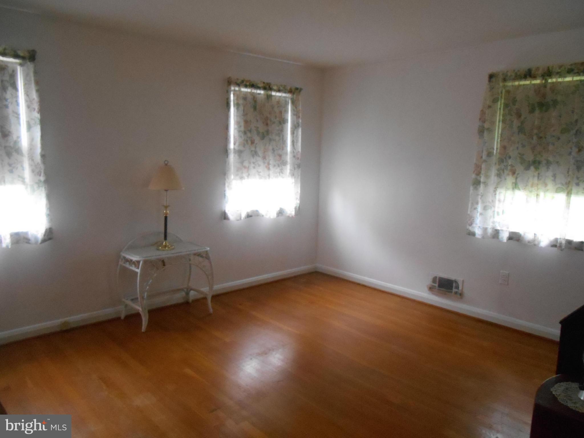 1414 Shefford Road Baltimore, MD 21239 - Photo 7 of 12 a view of a room with wooden floor and windows
