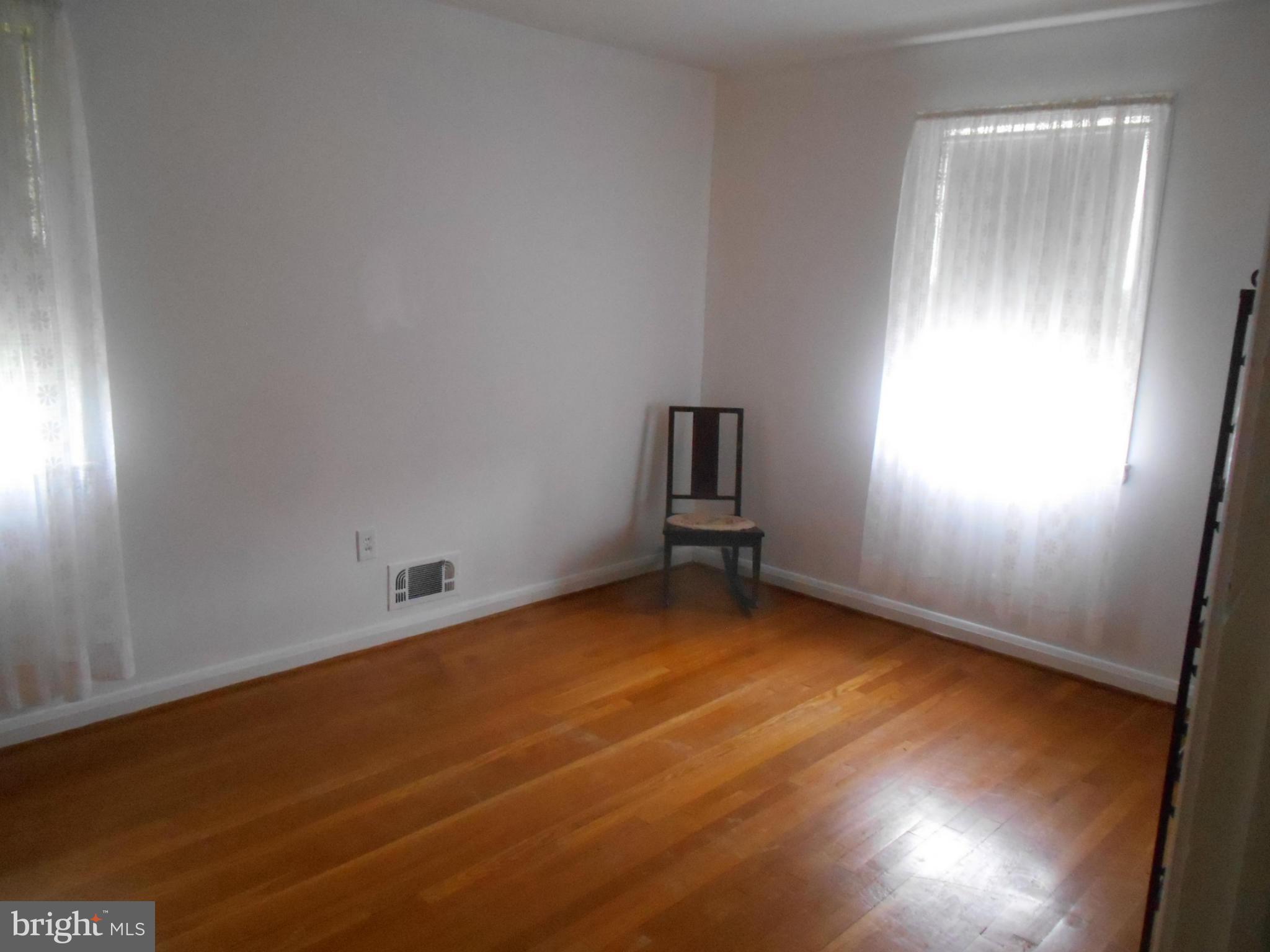 1414 Shefford Road Baltimore, MD 21239 - Photo 9 of 12 an empty room with windows