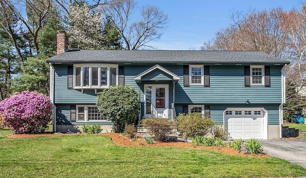 31 Hemlock Road Reading, MA 01867 - Photo 1 of 28 a front view of a house with a yard