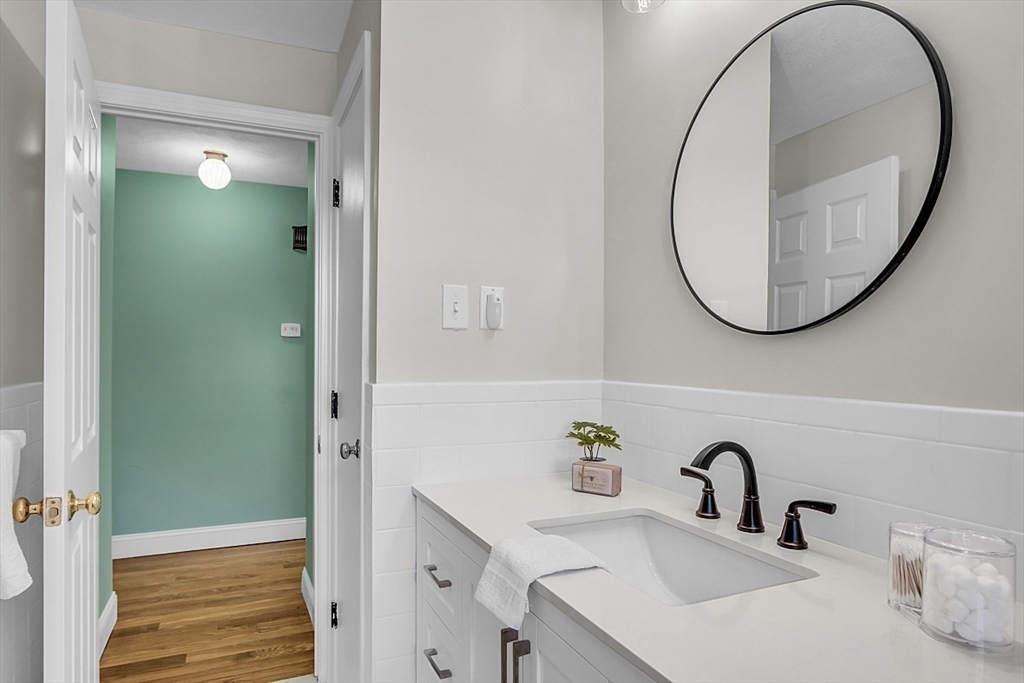 31 Hemlock Road Reading, MA 01867 - Photo 13 of 28 a bathroom with a sink and a mirror