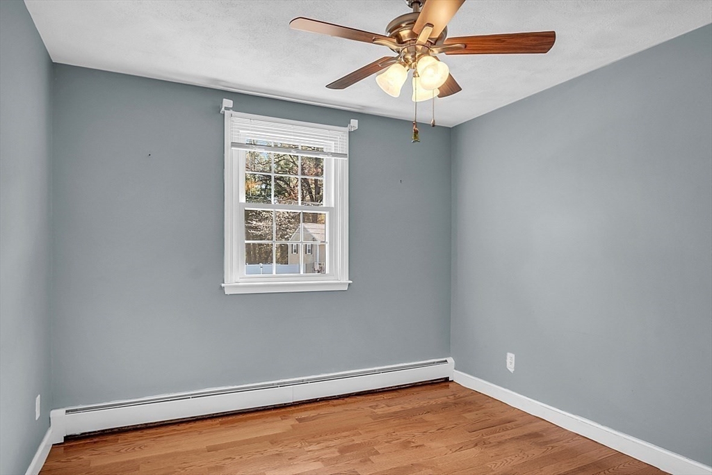 31 Hemlock Road Reading, MA 01867 - Photo 14 of 28 an empty room with a window and a fan