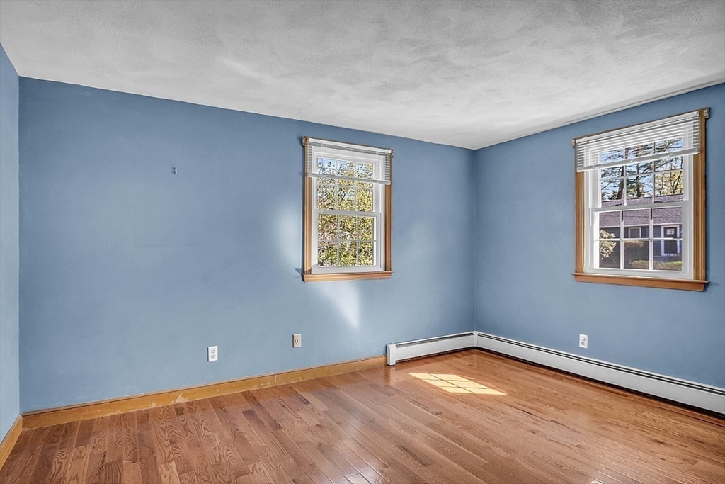 31 Hemlock Road Reading, MA 01867 - Photo 16 of 28 a view of an empty room with wooden floor and a window