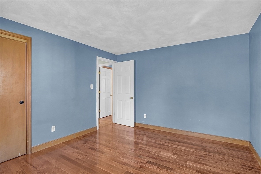 31 Hemlock Road Reading, MA 01867 - Photo 17 of 28 a view of an empty room with wooden floor and closet