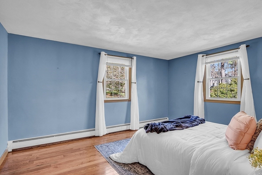 31 Hemlock Road Reading, MA 01867 - Photo 19 of 28 a bedroom with a bed and a window