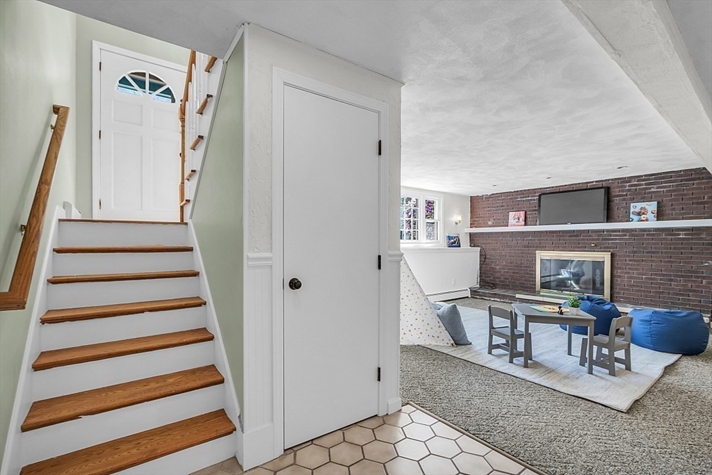 31 Hemlock Road Reading, MA 01867 - Photo 20 of 28 a living room with furniture and a fireplace