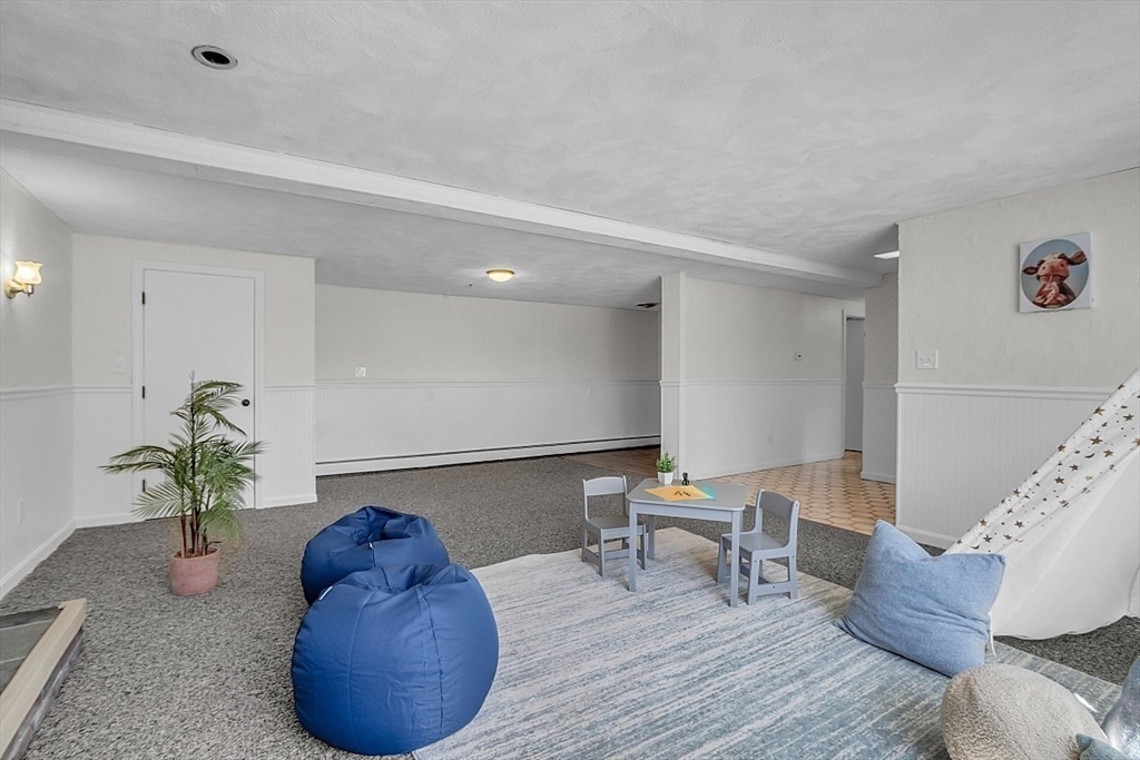 31 Hemlock Road Reading, MA 01867 - Photo 22 of 28 a living room with furniture and a potted plant