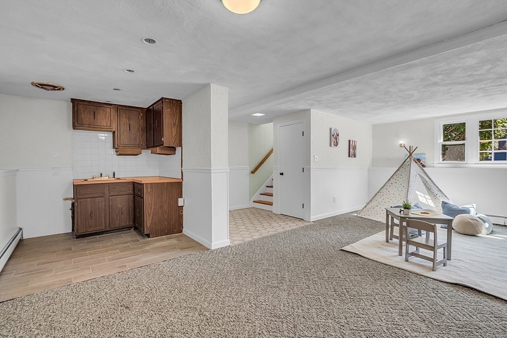 31 Hemlock Road Reading, MA 01867 - Photo 23 of 28 a view of a livingroom with furniture and staircase
