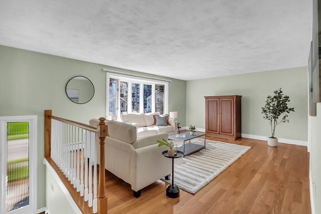31 Hemlock Road Reading, MA 01867 - Photo 4 of 28 a living room with furniture and wooden floor