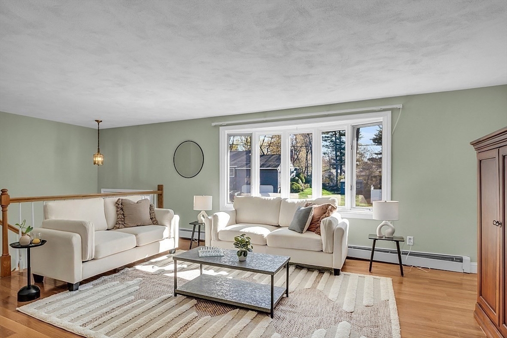 31 Hemlock Road Reading, MA 01867 - Photo 5 of 28 a living room with furniture and a large window