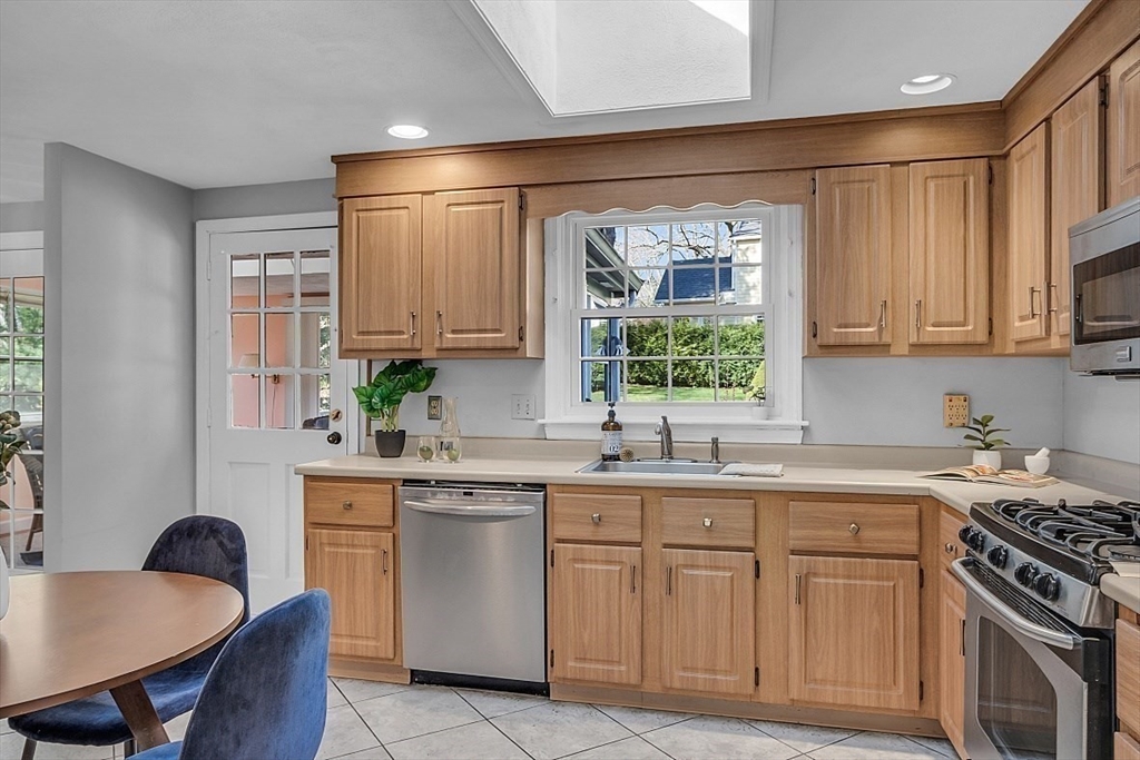 31 Hemlock Road Reading, MA 01867 - Photo 10 of 28 a kitchen with a sink stove and cabinets
